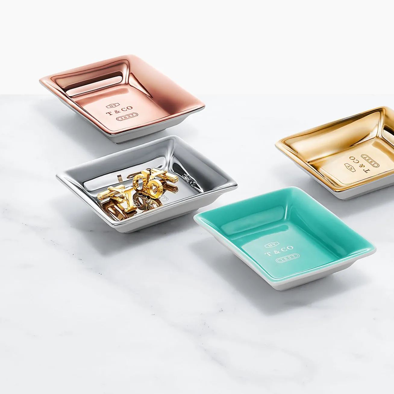 Tiffany & Co. Metallic vide poches in porcelain, set of four. | ^ The Home|Housewarming Gifts