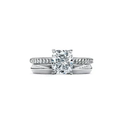 Tiffany & Co. Tiffany Novo® cushion-cut engagement ring with a pavé diamond band in platinum. | ^ Engagement Rings