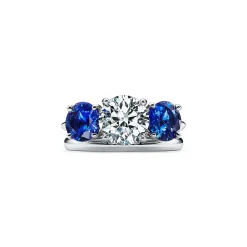 Tiffany & Co. Tiffany Three Stone engagement ring with sapphire side stones in platinum. | ^ Engagement Rings